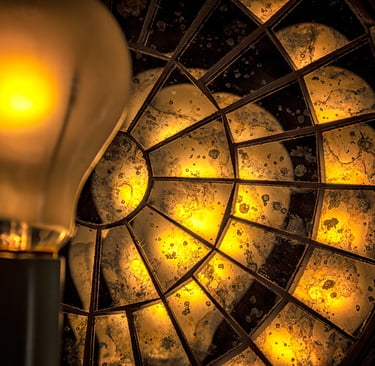 Photo of yellow lightbulb and reflecting disk