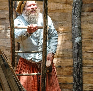 Photo of man at ladder from early American settlement