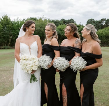 Bridesmaids gathered around the bride holding bouquets at London Shenley Club