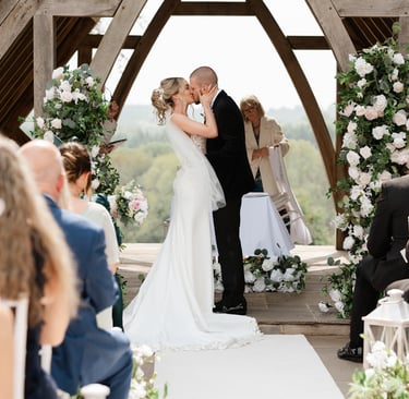 Bride and groom sharing their first kiss at Highley Manor