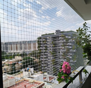 Evening view of a balcony with pigeon netting, showing the net’s durability under natural light.