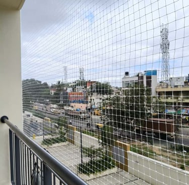Happy family enjoying their balcony protected by a sturdy safety net in Coimbatore.