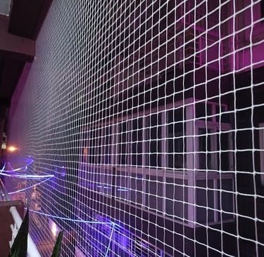 Close-up of a freshly installed pigeon net on a balcony in Mumbai, showing fine mesh and secure fitt