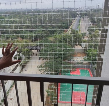 A child playing safely behind a securely installed balcony net.