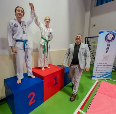 2024 Hwa Rang Tournament Winners on Podium with Master Carlos Bazan