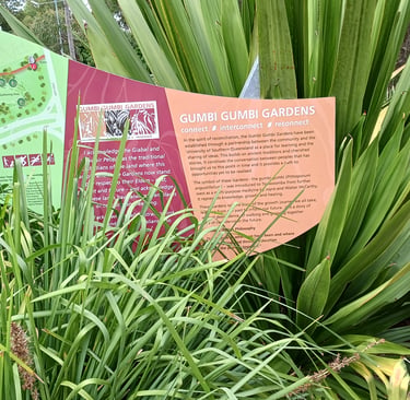Informational signage and garden map at Gumbi Gumbi Gardens featuring indigenous plant education and history.
