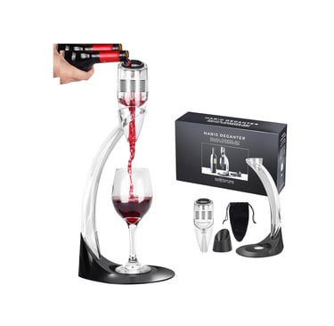 a wine glass being poured with red wine