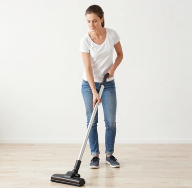 A smiling cleaner in a light blue uniform holding eco-friendly cleaning supplies.