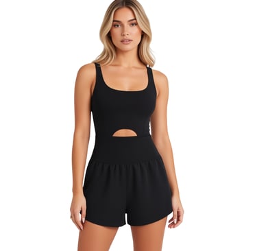 Woman in black athletic romper with cutout waist detail on white background