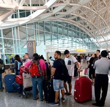 view of an airport with tourists standing in que