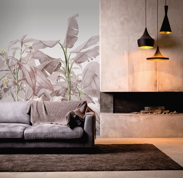 Modern living room featuring tropical leaf wallpaper, a gray sofa, and a concrete fireplace with pendant lights.