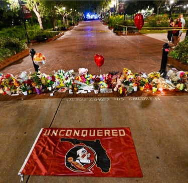 Students hold a vigil near the Florida State University student center on Thursday.