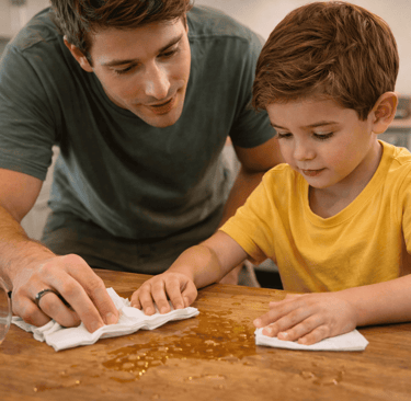 Father and son clean up spill