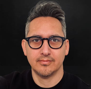 The author with glasses and a black shirt