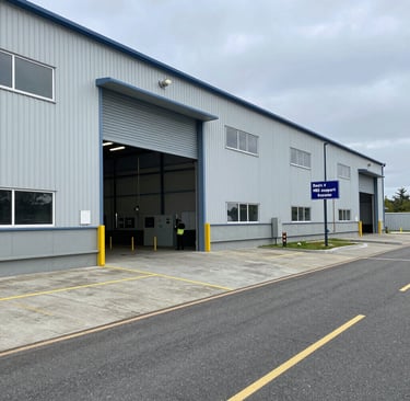 Technician checking HVAC system controls inside a modern commercial building.