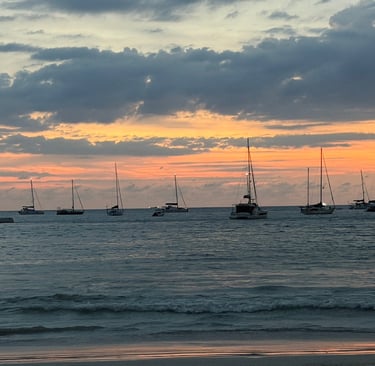 Sunset ocean view with sailing yachts anchored at Nai Harn bay Phuket