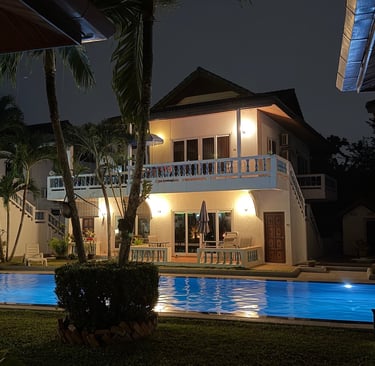 Illuminated swimming pool at night at Yanui Apartments Phuket villa rental