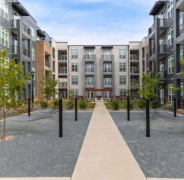 Central courtyard with hammocks between multi-story apartment buildings at Leo Loso in Charlotte, North Carolina.