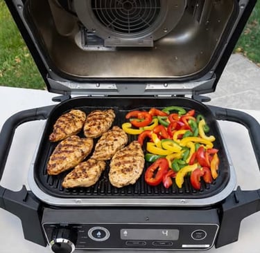Grilled chicken breasts and sliced bell peppers cooking on an open electric grill outdoors