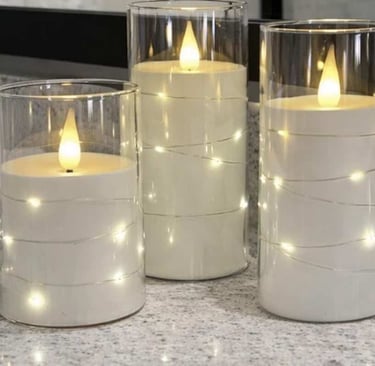 Three gray pillar candles with flickering LED flames and internal star string lights are displayed