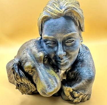 A 3D printed bronze and silver bust featuring a woman hugging her loyal golden retriever dog.