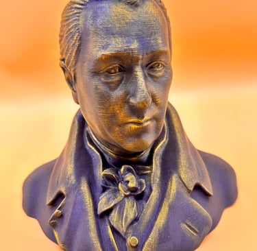 A 3D printed bust of a historical figure with a bronze and purple metallic finish on an orange background.