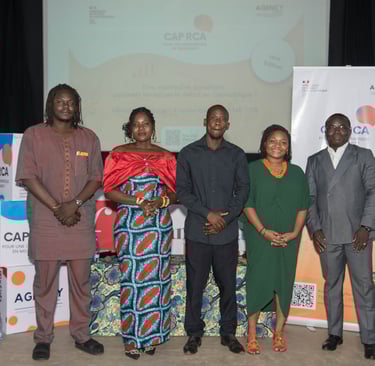 Professional group of African business leaders posing together in formal attire in front of a building.