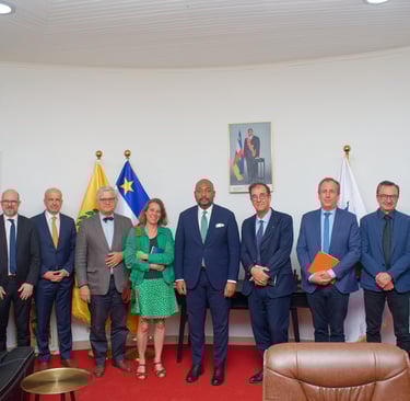Professional group portrait of international delegates standing together for a formal diplomatic meeting.