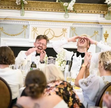 same-sex couple enjoying speeches after their wedding at The Trafalgar Tavern Greenwich