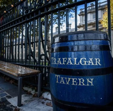 A blue wooden barrel with Trafalgar Tavern lettering outside the historic Greenwich pub in London.