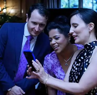 wedding guests looking at a mobile phone