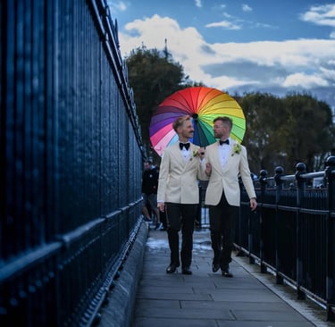 same-sex couple walking along the riverside next to The Trafalgar Tavern Greenwich
