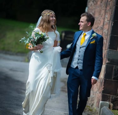 bride and groom walking around church grounds
