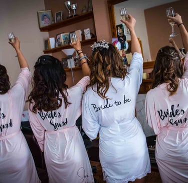 bride and bridemaid raising a glass of champagne