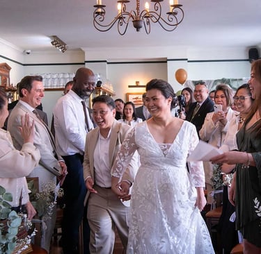 wedding couple walking down the aisle being cheered on by friends and family