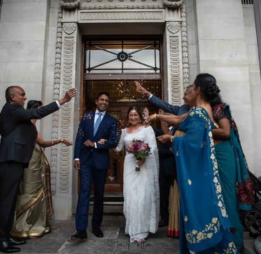 newly-weds being showered with confetti on old marylebone town hall steps