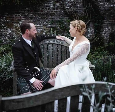 newly-weds sitting on a park bench