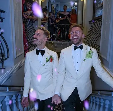 newly-weds enjoying their congetti moment on the stairs in The Trafalgar Tavern Greenwich