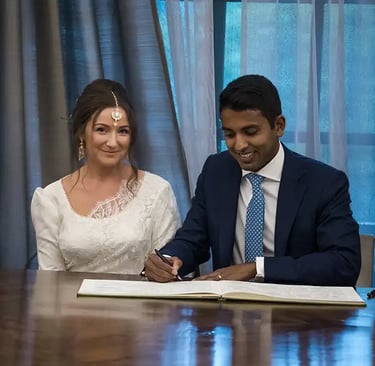 newly-weds signing the register in the westminster room at old marylebone town hall