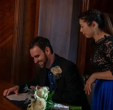 newly-weds signing the register in the marybone room at old marylebone town hall