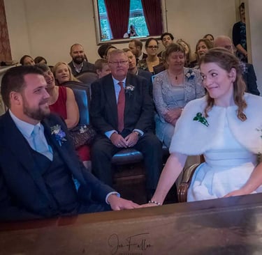 Newly weds holding hands in the Garden Room in Southwark Registry Office