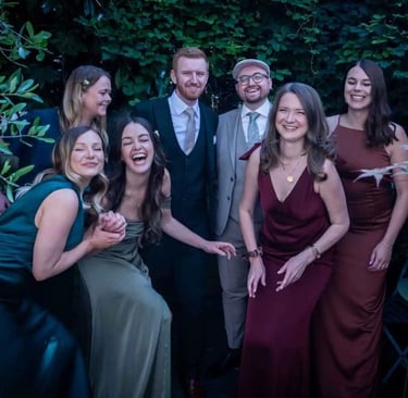 same-sex couple enjoying time with their wedding party before travelling to The Asylum Chapel Peckham