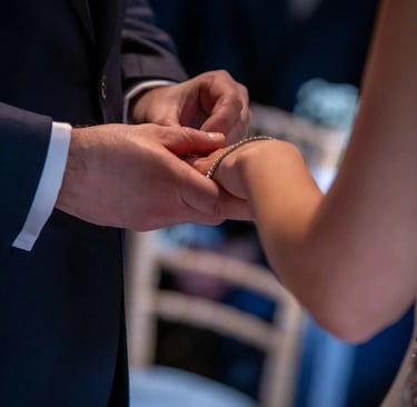 groom placing wedding ring on his bride's finger
