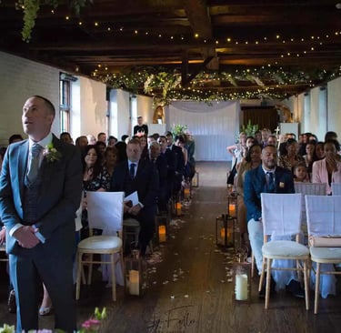 Groom waiting for his bride to walk up the aisle