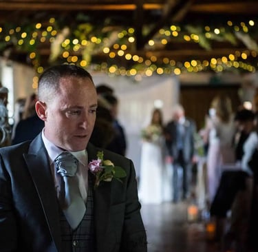 Groom waiting for his bride to walk up the aisle