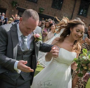 Newly-weds running through confetti