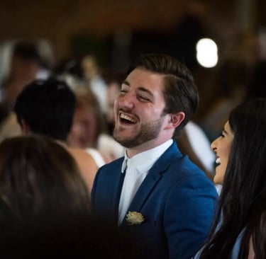 male wedding guest laughing