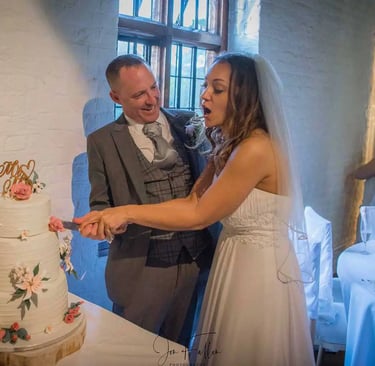 Wedding couple cutting their cake in Tudor Barn Eltham