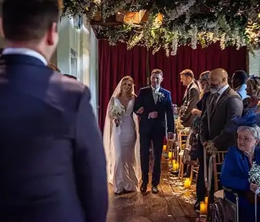 Vickie walking toward her new husband at Tudor Barn Eltham