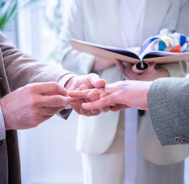 two grooms  holding hands in a wedding ceremony